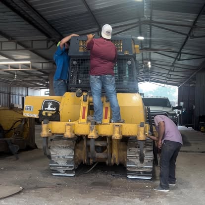 Crew servicing a dozer in the shop
