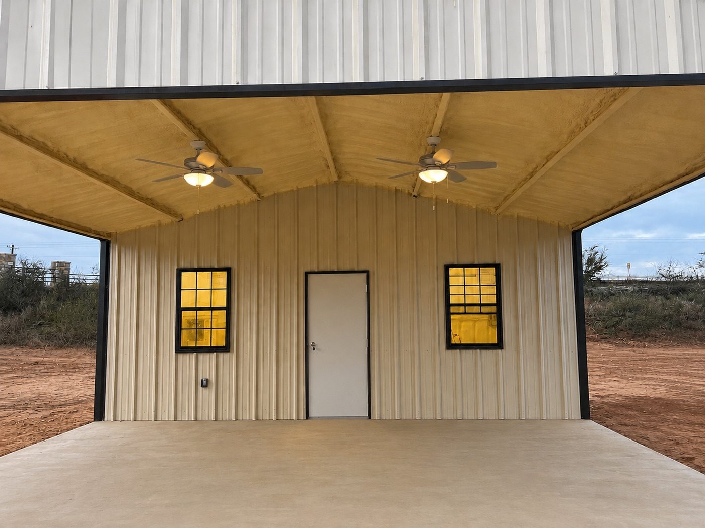 Finished metal building with a covered porch and open bay